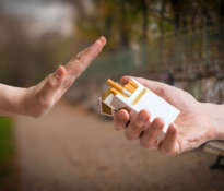 Quitting smoking concept. Hand is rejecting cigarette offer.